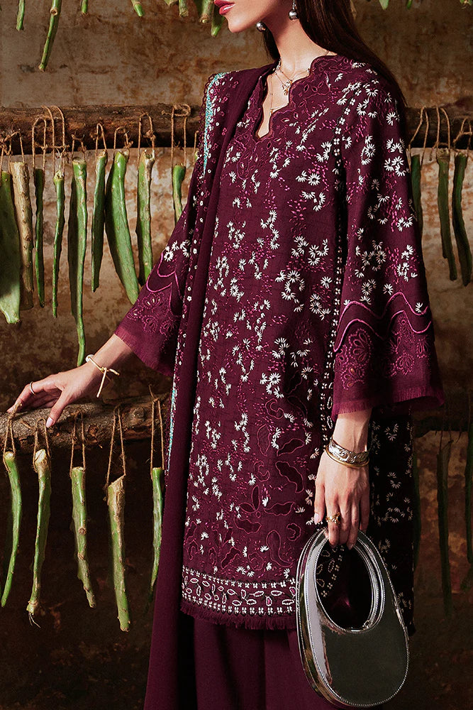 Model wearing Omya by Suffuse in deep maroon with intricate embroidery – sophisticated Pakistani luxury pret outfit in UK.