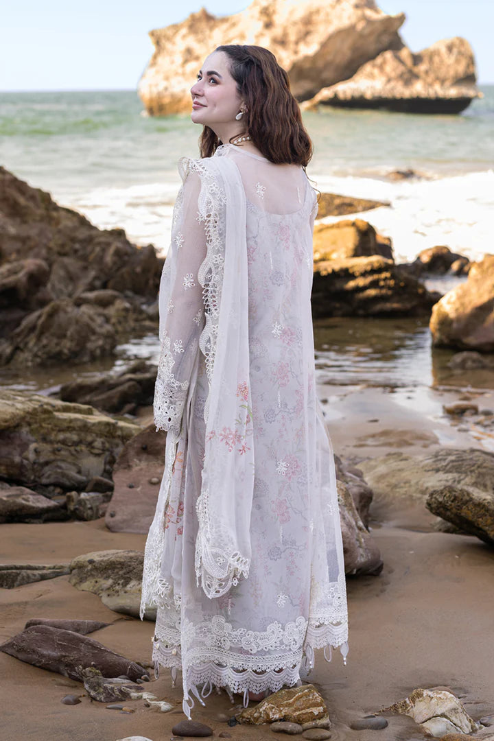 Model wearing Qalamkar's FP - 11 EMIRA dress in soft lavender with intricate embroidery, available in the UK. Ideal for luxury lawn suits and Pakistani clothes online.