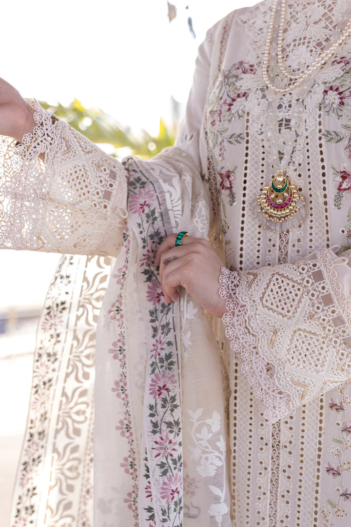 Model wearing a white FP - 12 MARWA dress from Qalamkar with intricate embroidery, standing against a beach background. Pakistani clothes online in UK, lawn suits.