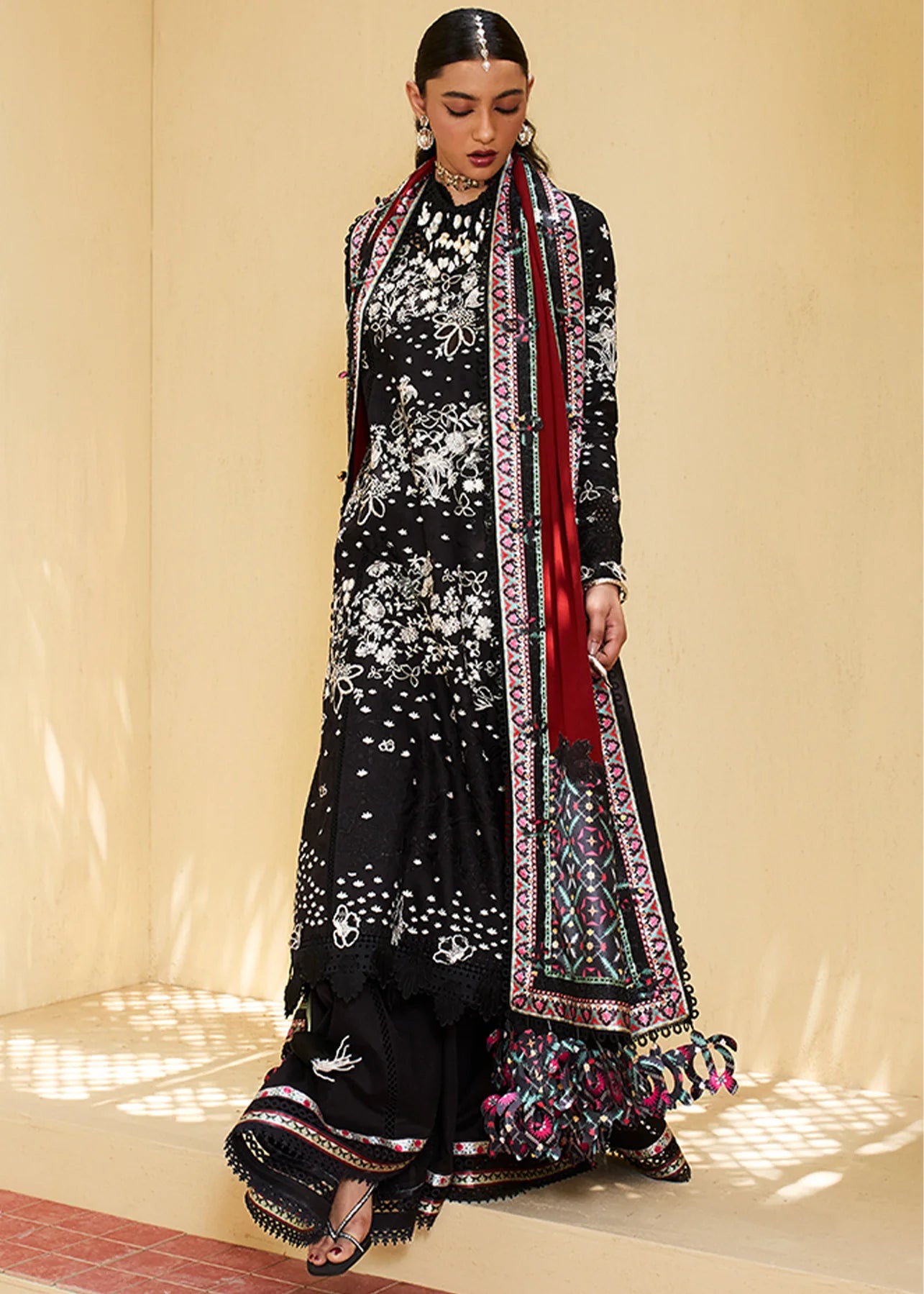 Model wearing black embroidered Kiran outfit from Suffuse Lawn Eid Edit '25, Pakistani luxury pret and Pakistani clothes online in UK.