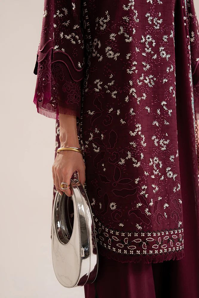 Model wearing Omya by Suffuse in deep maroon with intricate embroidery – sophisticated Pakistani luxury pret outfit in UK.