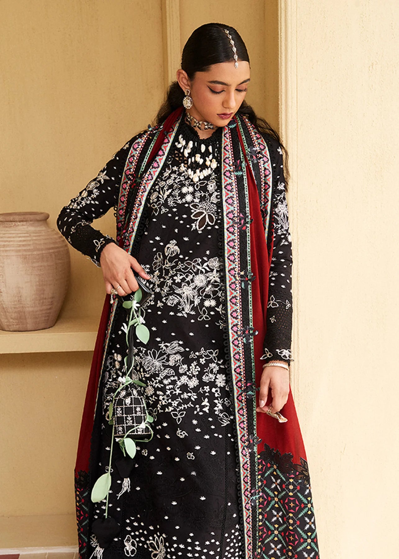 Model wearing black embroidered Kiran outfit from Suffuse Lawn Eid Edit '25, Pakistani luxury pret and Pakistani clothes online in UK.