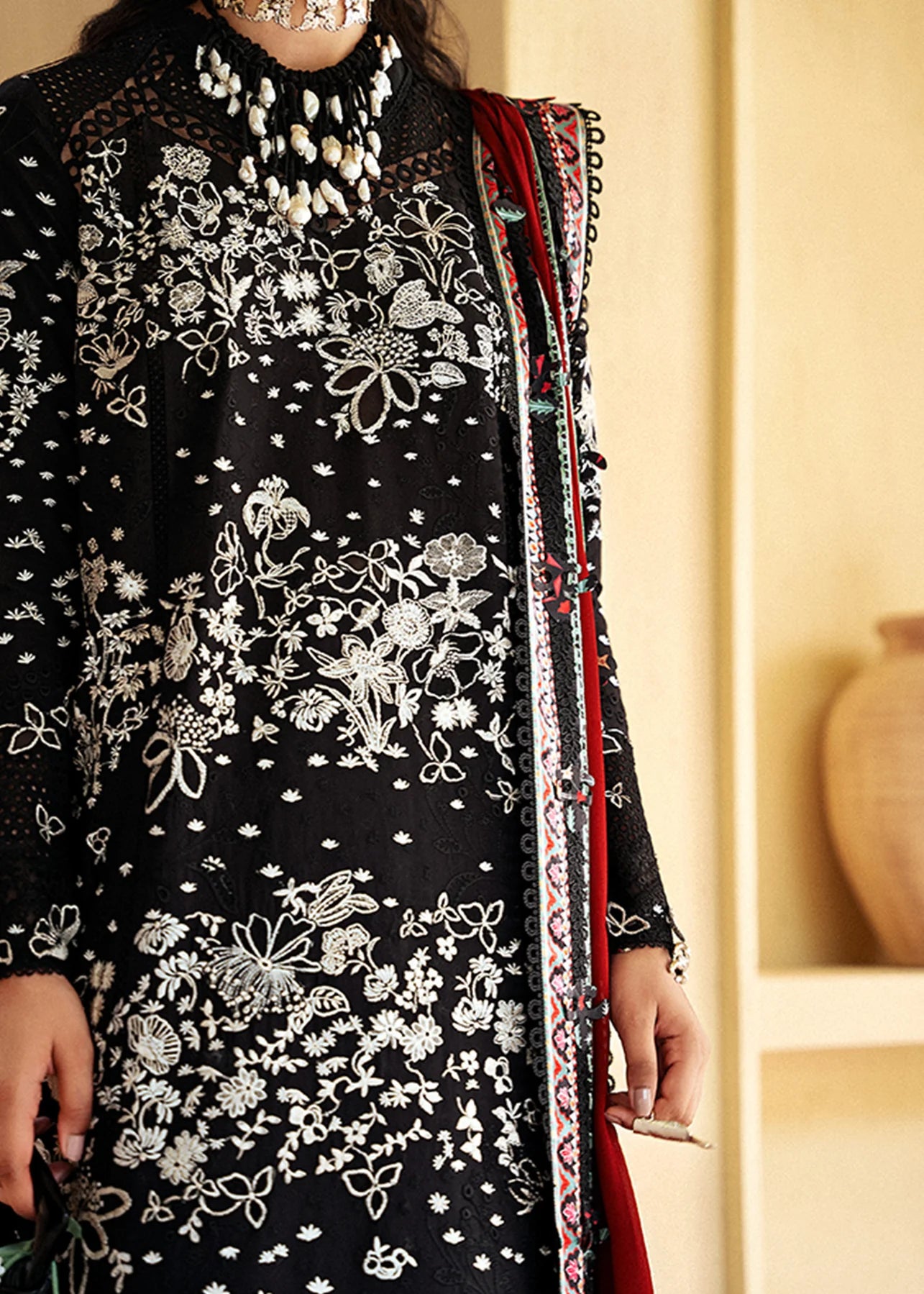 Model wearing black embroidered Kiran outfit from Suffuse Lawn Eid Edit '25, Pakistani luxury pret and Pakistani clothes online in UK.