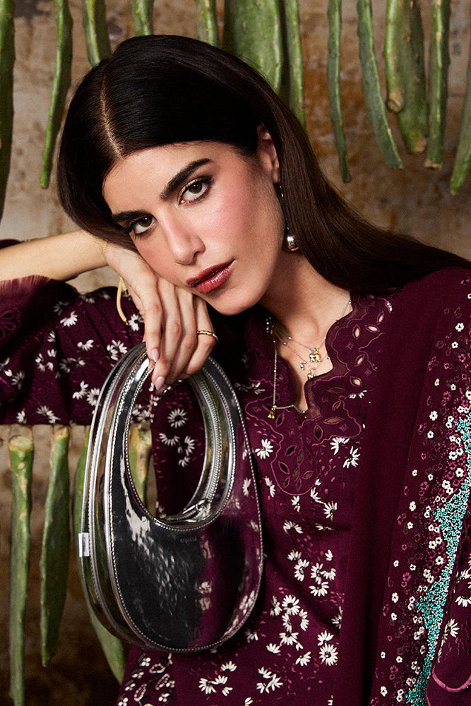 Model wearing Omya by Suffuse in deep maroon with intricate embroidery – sophisticated Pakistani luxury pret outfit in UK.