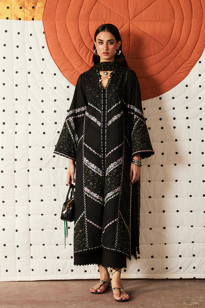 Model wearing Sazil by Suffuse in black with floral patterns and lace details – stylish Pakistani luxury pret outfit in UK.