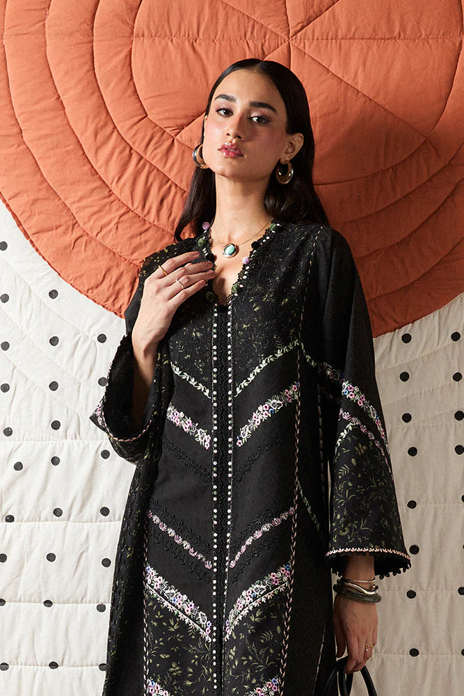 Model wearing Sazil by Suffuse in black with floral patterns and lace details – stylish Pakistani luxury pret outfit in UK.
