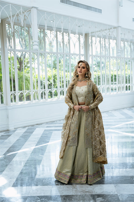 Model wearing Marigold from Mysie by Tahira, a golden-hued ensemble with intricate embroidery, ideal for Pakistani luxury pret in the UK.