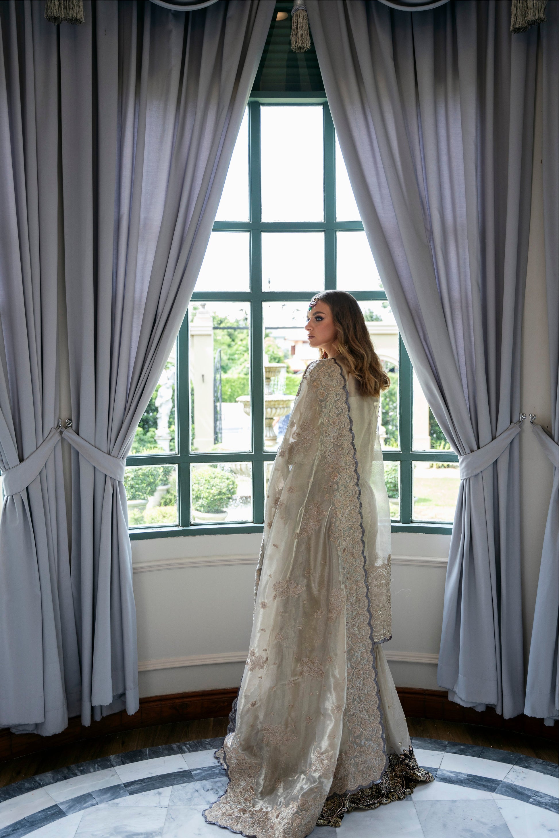 Model wearing Arya from Mysie by Tahira in beige with intricate embellishments, perfect for Pakistani luxury pret in the UK.
