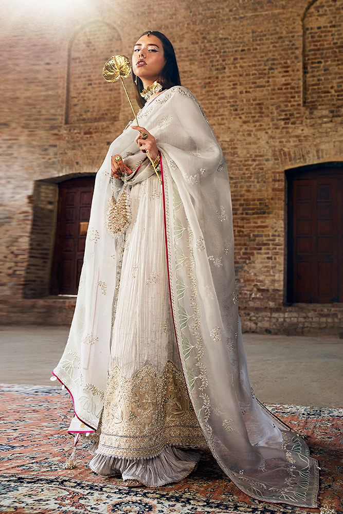 Model wearing NEVE, side angle, a Pakistani designer outfit by Suffuse, available online in the UK.