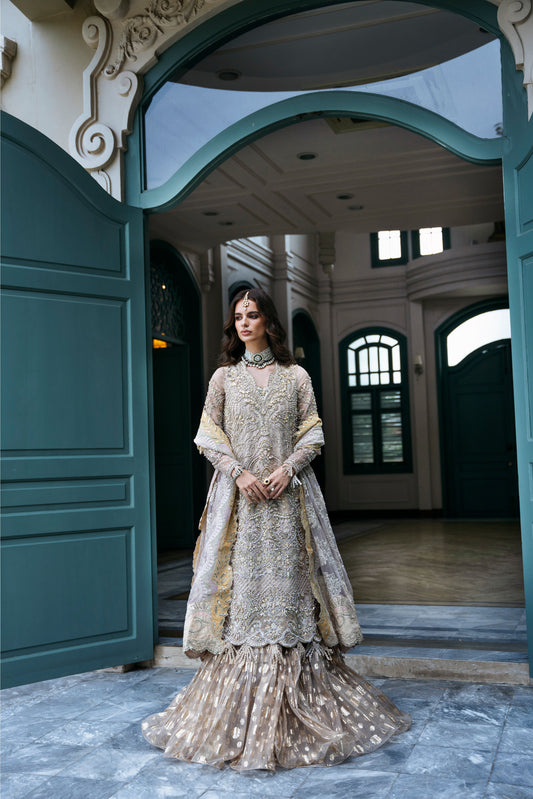 Model wearing PEONY from Mysie by Tahira, a soft beige and gold embellished ensemble, perfect for Pakistani luxury pret in the UK.