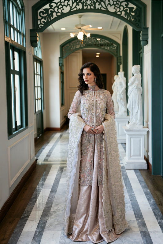 Model wearing Arsh from Mysie by Tahira, a stunning beige luxury pret outfit with intricate embroidery, perfect for Pakistani clothes in the UK.