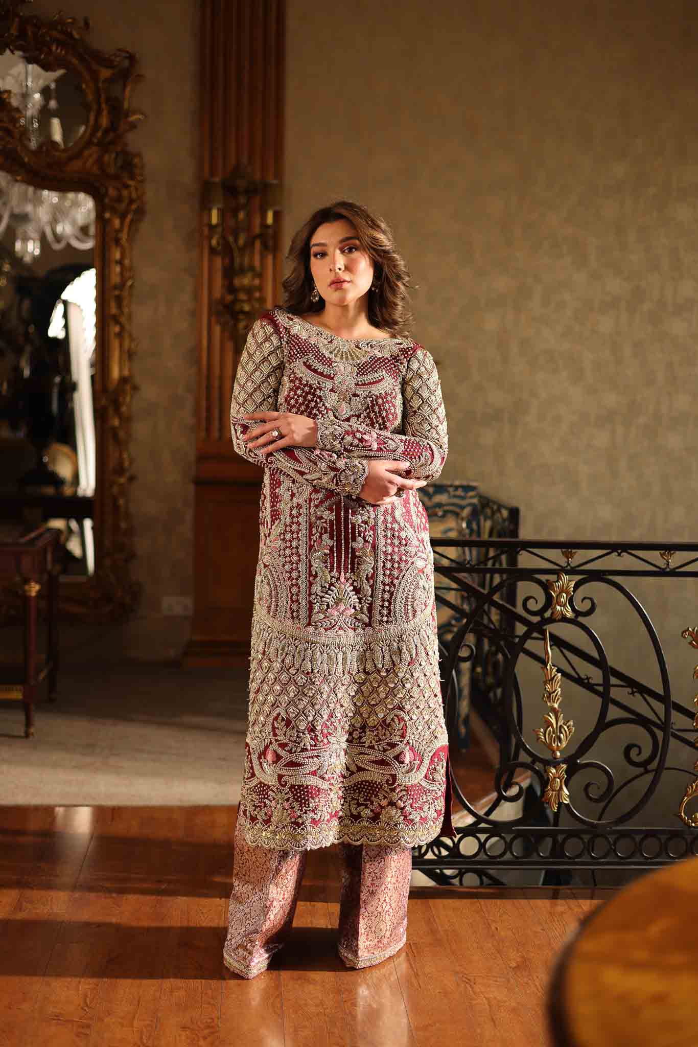 Model wearing deep maroon and gold hand-embellished long shirt with matching trousers from Mysie By Tahira Ruby, Pakistani Luxury pret UK.