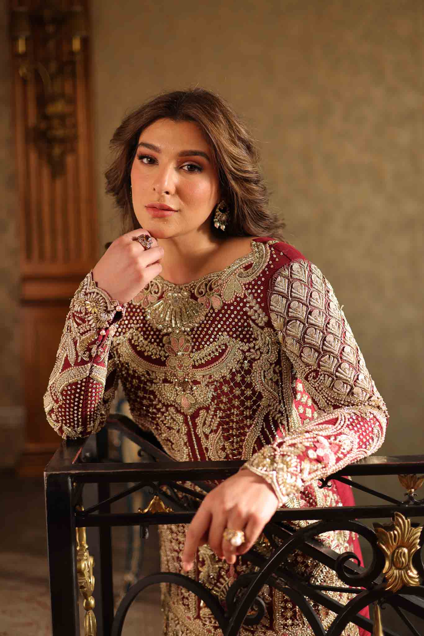Model wearing deep maroon and gold hand-embellished long shirt with matching trousers from Mysie By Tahira Ruby, Pakistani Luxury pret UK.