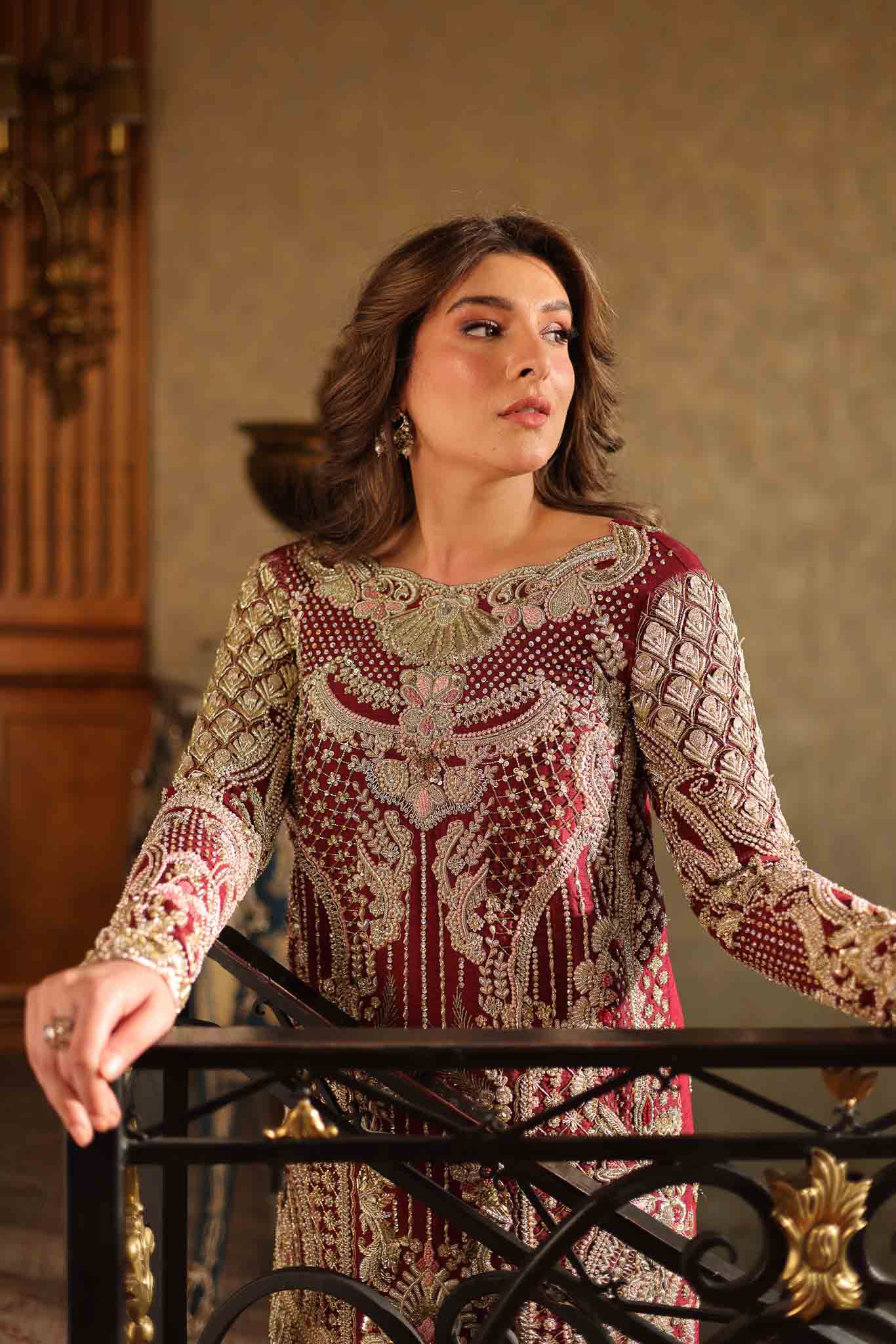 Model wearing deep maroon and gold hand-embellished long shirt with matching trousers from Mysie By Tahira Ruby, Pakistani Luxury pret UK.