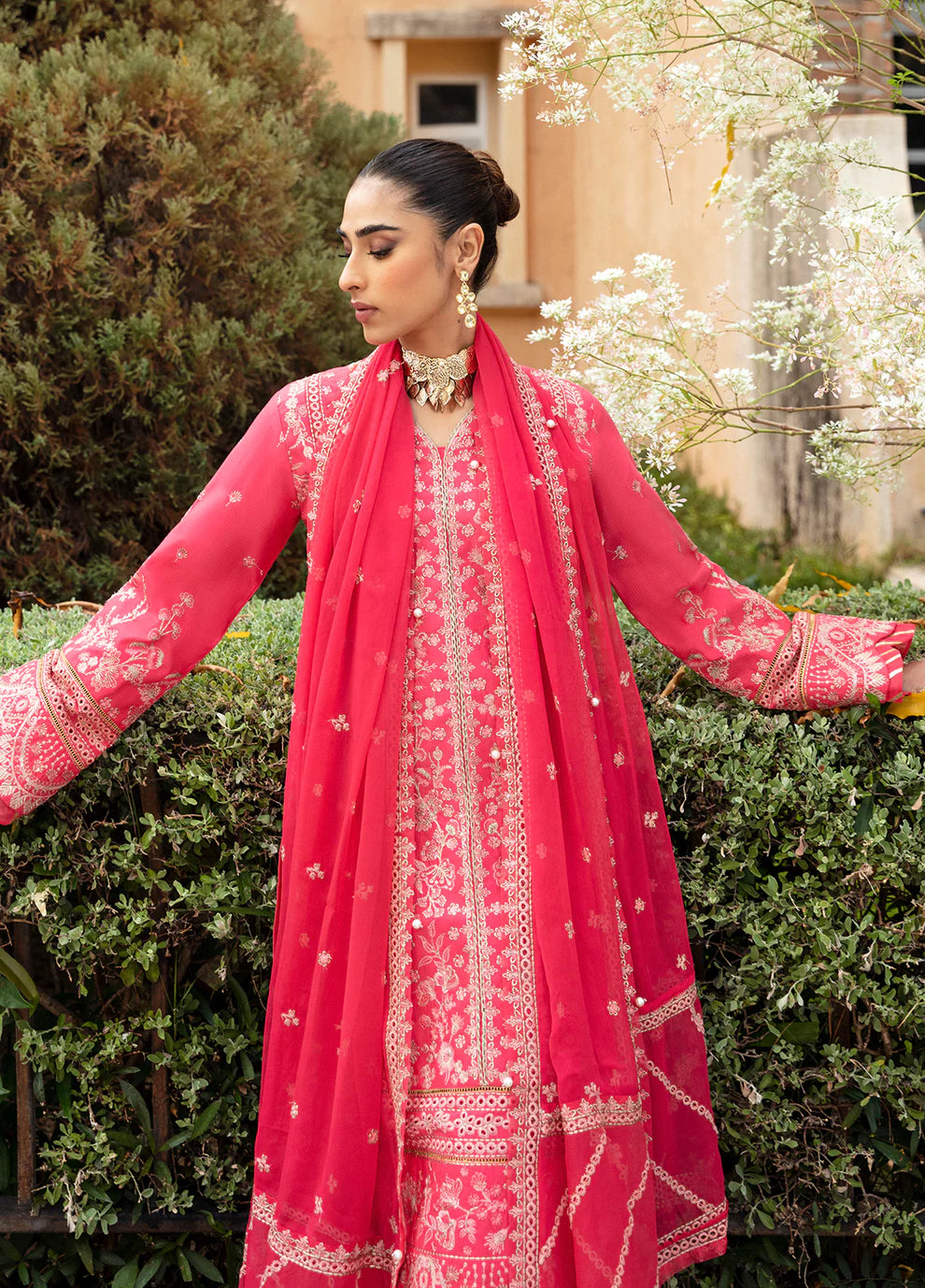 Model in Gulaal's ALESSIA dress, pink luxury lawn with exquisite detailing, a UK Pakistani fashion staple.