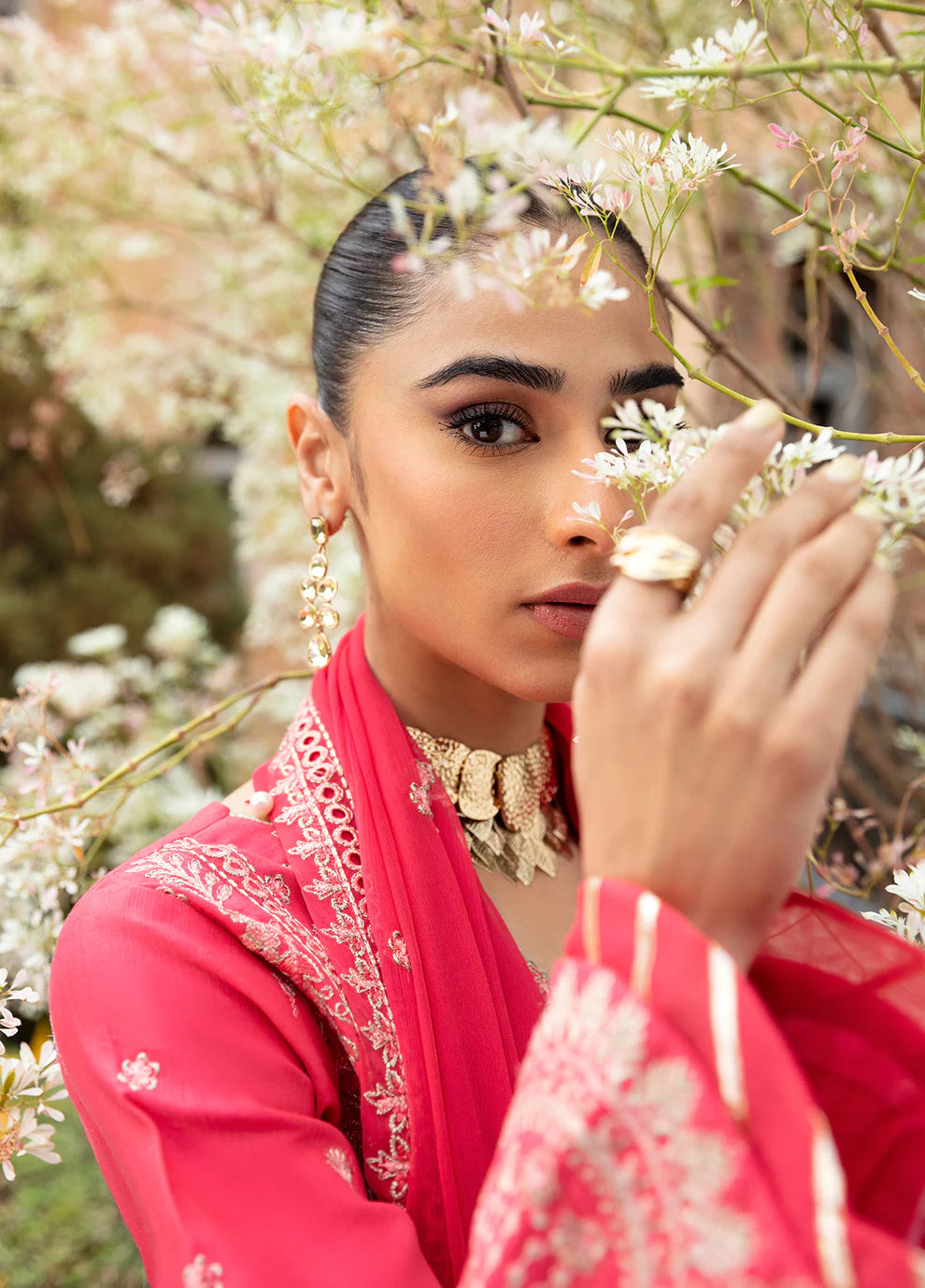 Model in Gulaal's ALESSIA dress, pink luxury lawn with exquisite detailing, a UK Pakistani fashion staple.