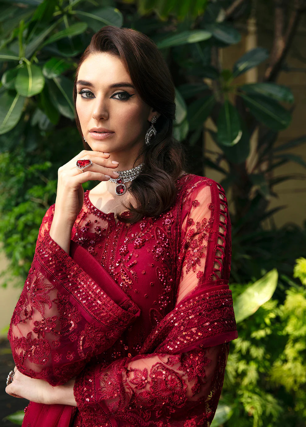 Model wearing Gulaal CHARLOTTE red embellished dress, UK Pakistani luxury attire.