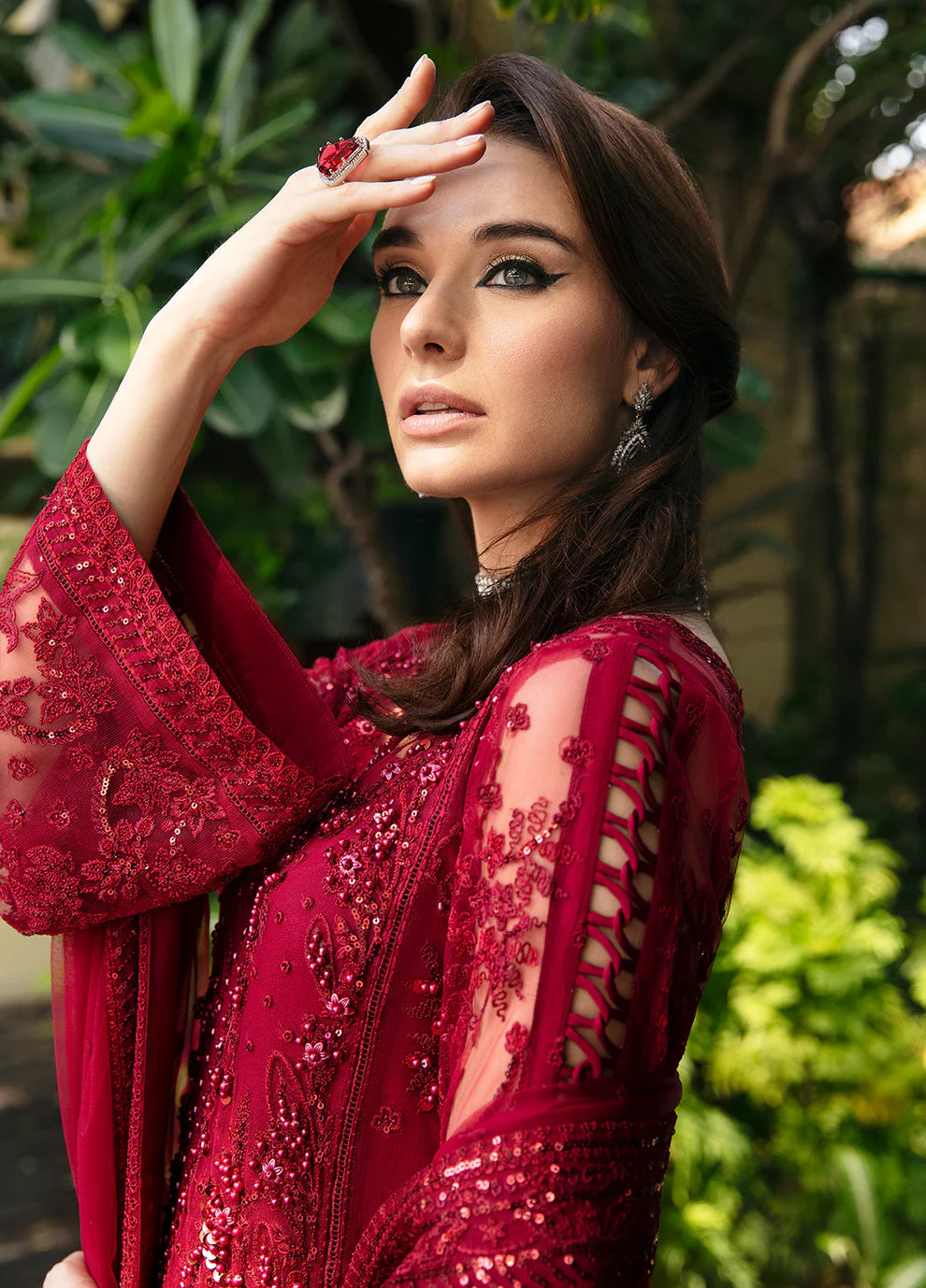 Model wearing Gulaal CHARLOTTE red embellished dress, UK Pakistani luxury attire.