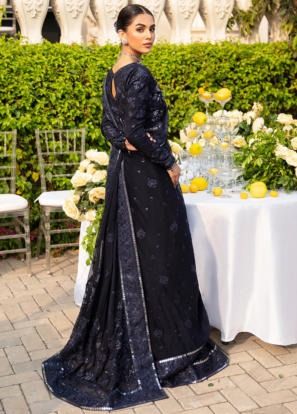 Model dons LEENA Gulaal UK dress, '23 Unstitched Pakistani wedding attire, intricate design.