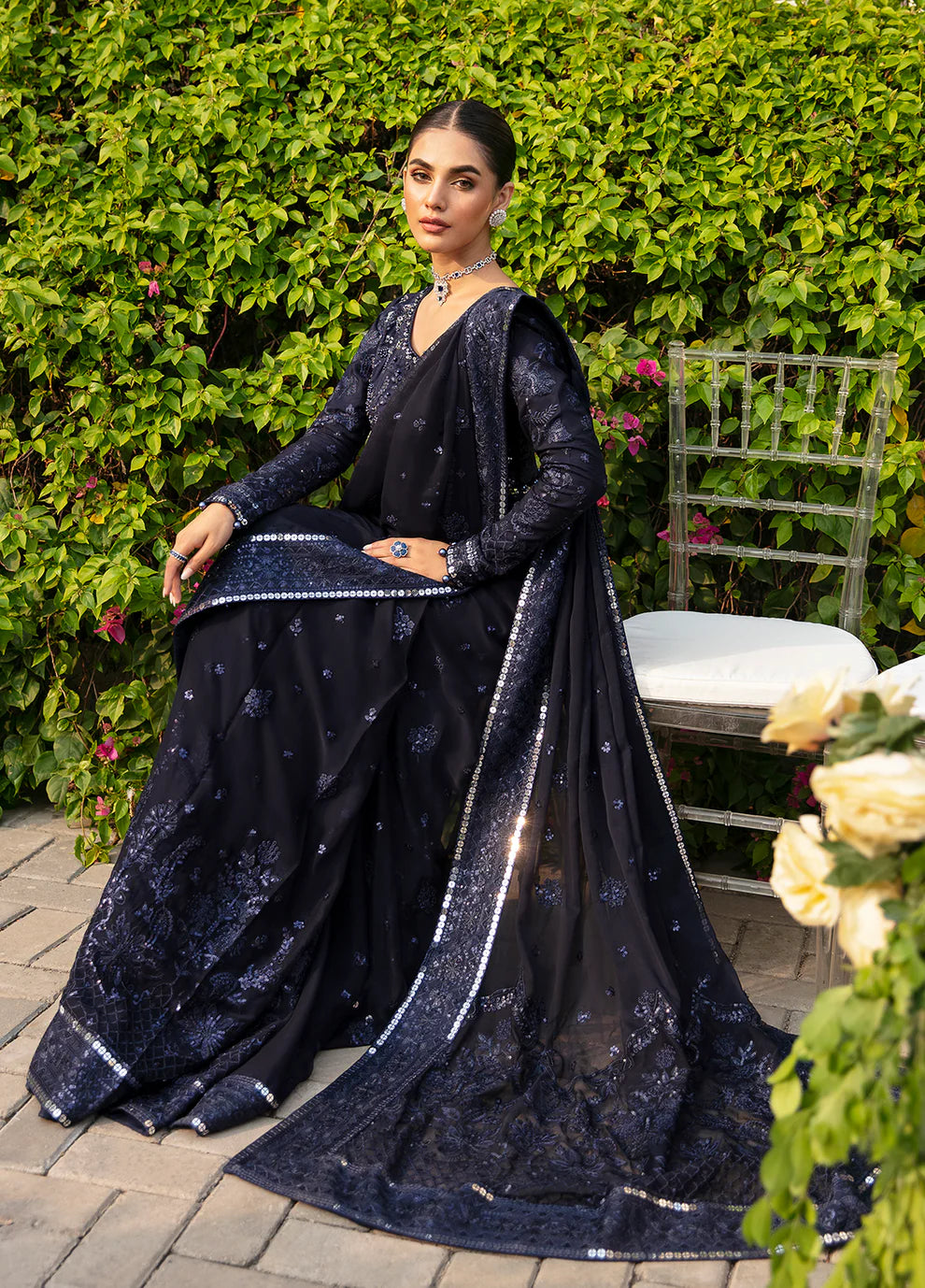 Model dons LEENA Gulaal UK dress, '23 Unstitched Pakistani wedding attire, intricate design.