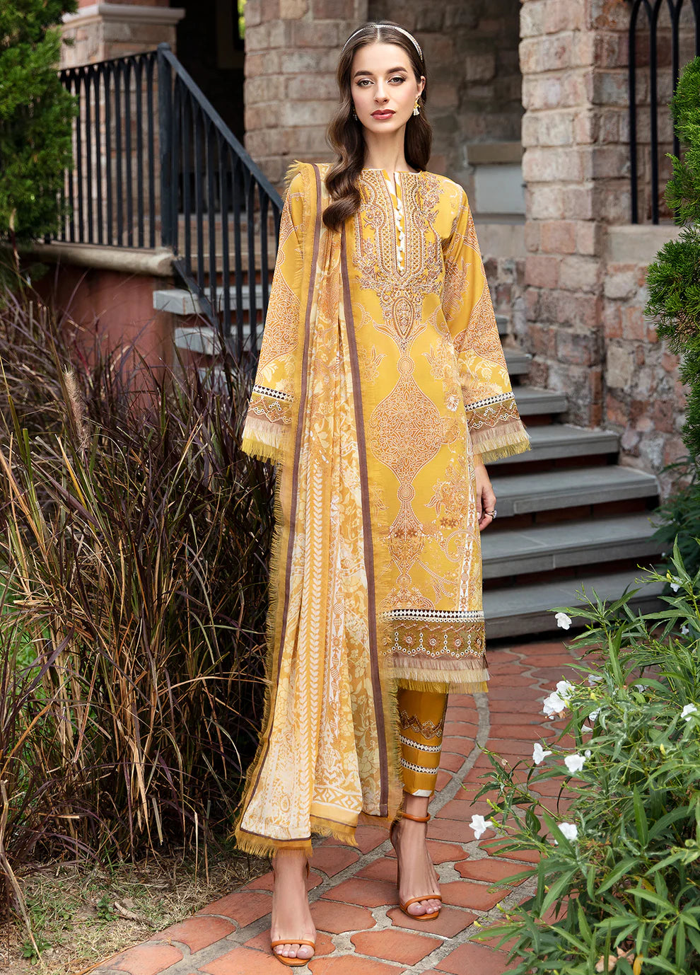 Model in Gulaal CEYDA dress, vibrant setting.