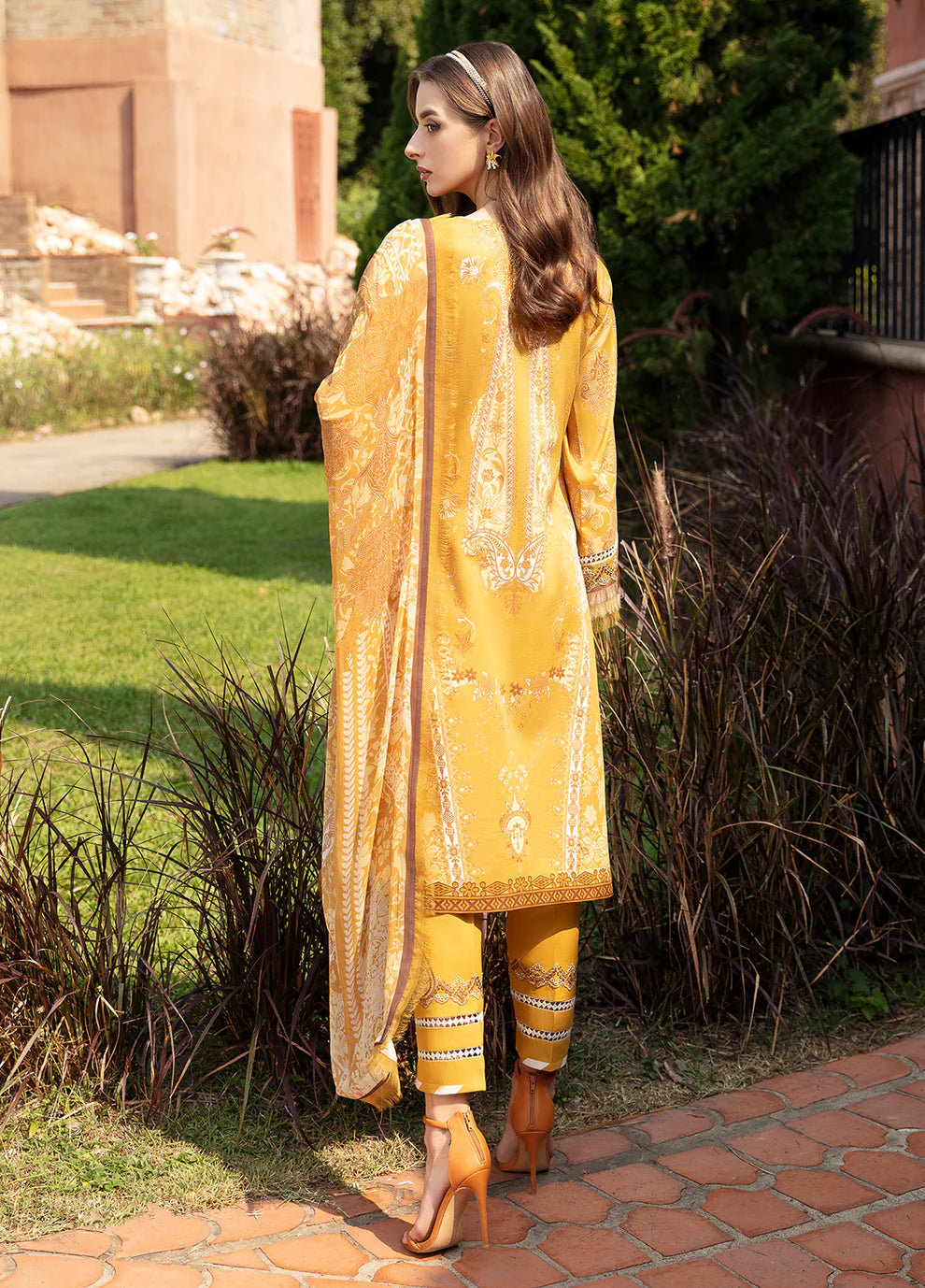 Model in Gulaal CEYDA dress, vibrant setting.