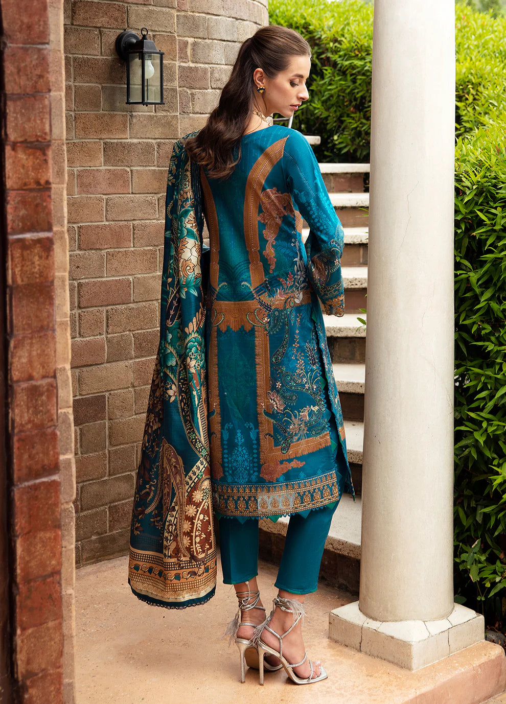 Model in Gulaal ESILA dress, teal with gold embroidery.