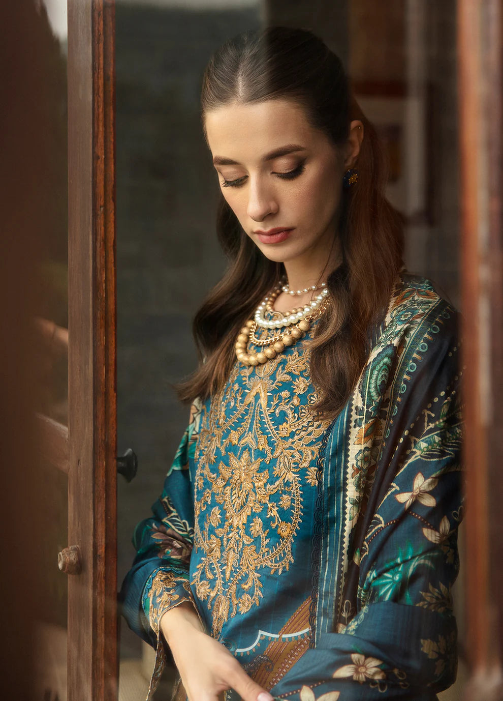 Model in Gulaal ESILA dress, teal with gold embroidery.