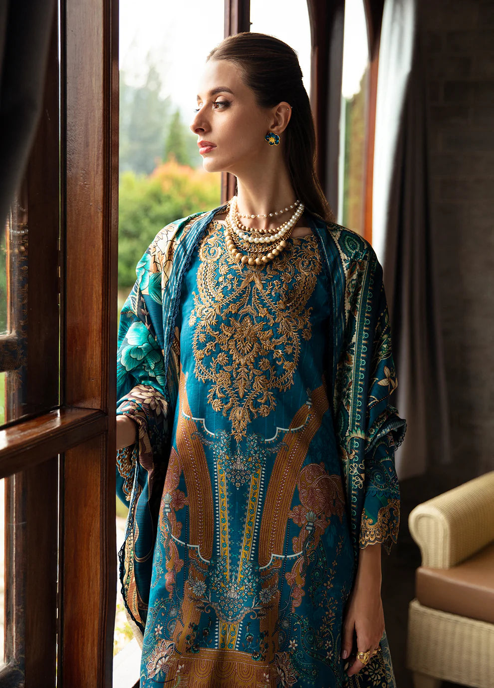 Model in Gulaal ESILA dress, teal with gold embroidery.