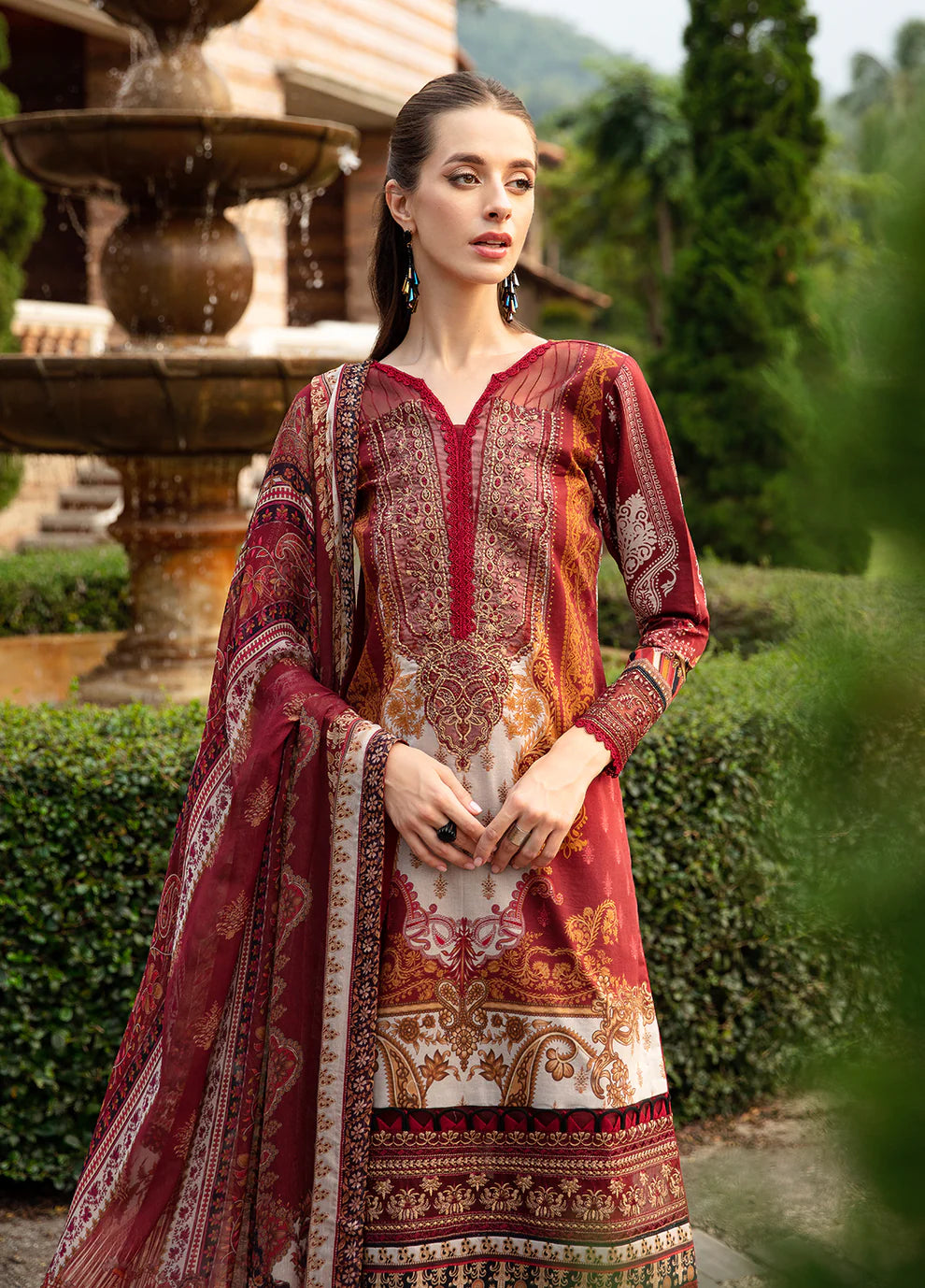 Elegant model in Gulaal's AMARYLLIS attire, rich maroon with gold print