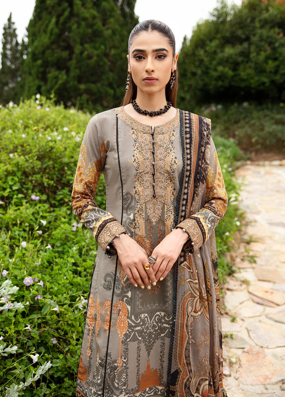 Model in Gulaal's AMIRAT dress, earth tones with luxe patterns