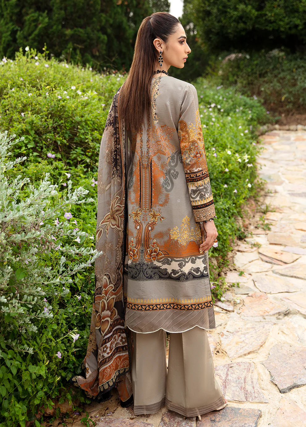 Model in Gulaal's AMIRAT dress, earth tones with luxe patterns