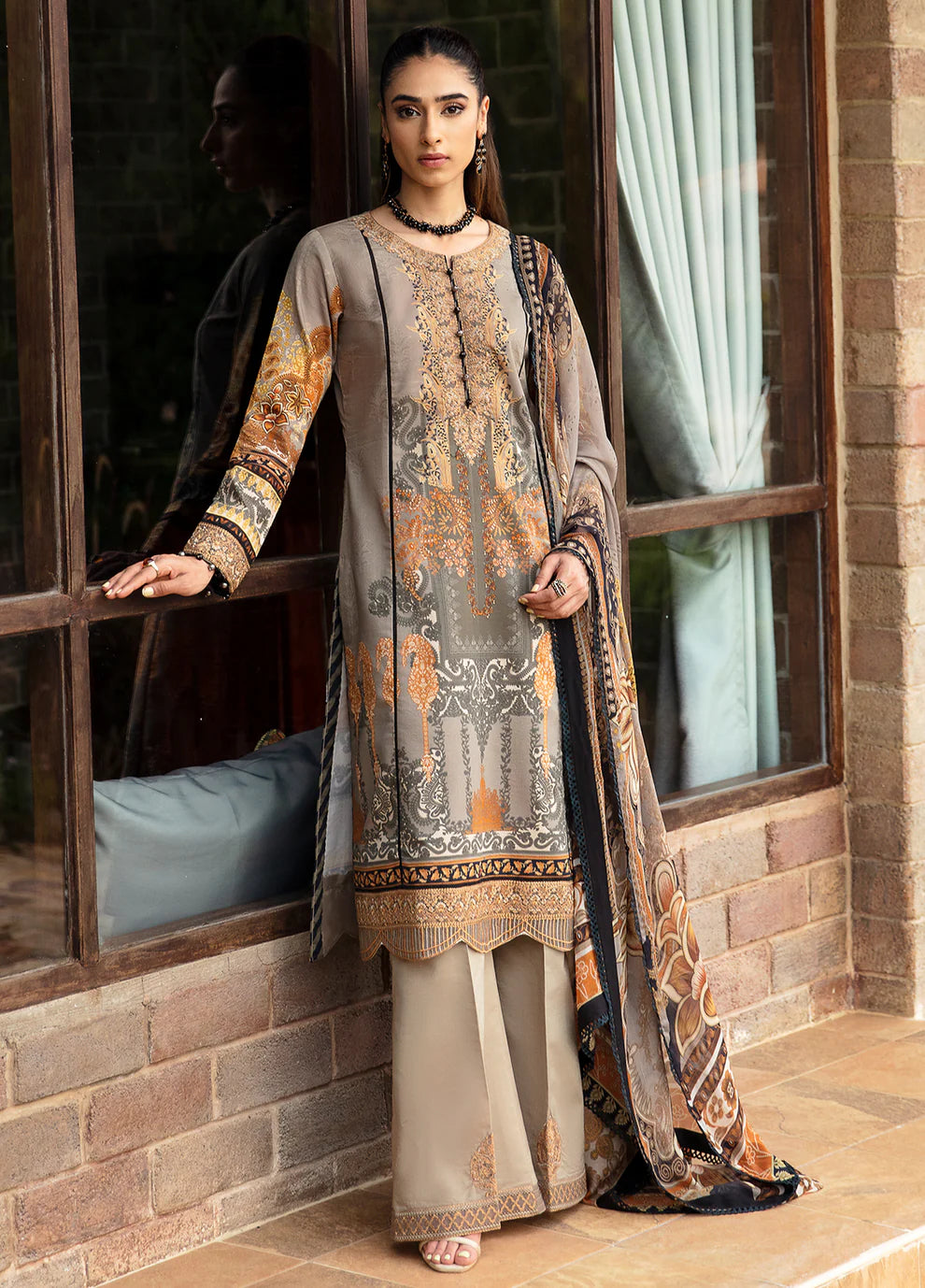 Model in Gulaal's AMIRAT dress, earth tones with luxe patterns