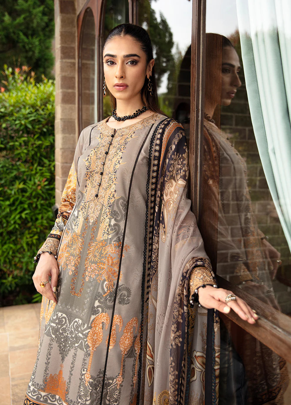 Model in Gulaal's AMIRAT dress, earth tones with luxe patterns