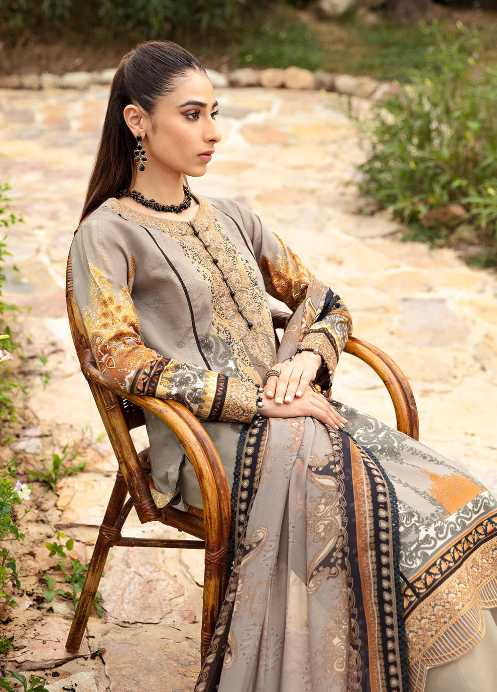 Model in Gulaal's AMIRAT dress, earth tones with luxe patterns