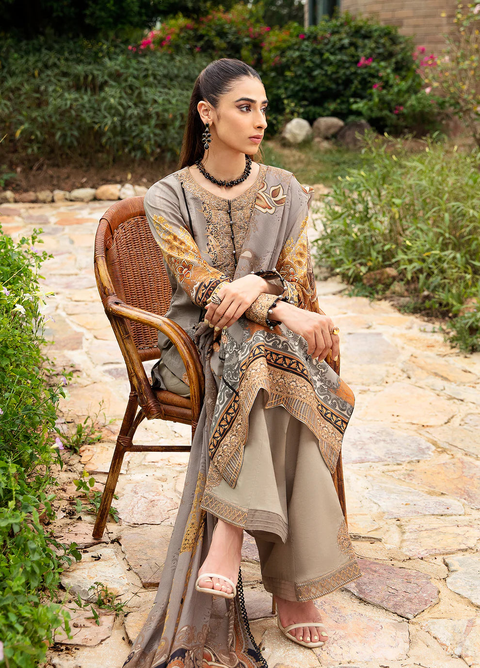 Model in Gulaal's AMIRAT dress, earth tones with luxe patterns