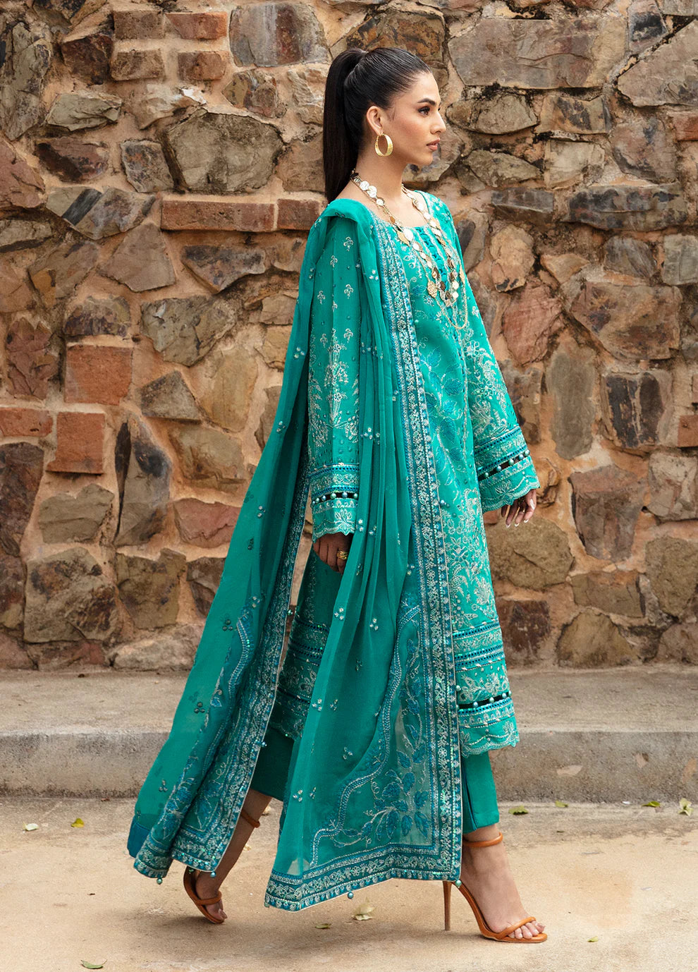 Elegant model in Gulaal's CIANA outfit, teal Pakistani attire, perfect for UK's ethnic wardrobe.