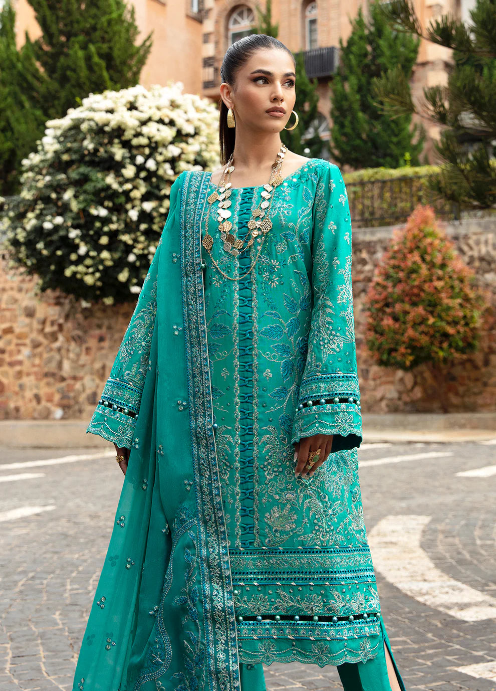 Elegant model in Gulaal's CIANA outfit, teal Pakistani attire, perfect for UK's ethnic wardrobe.