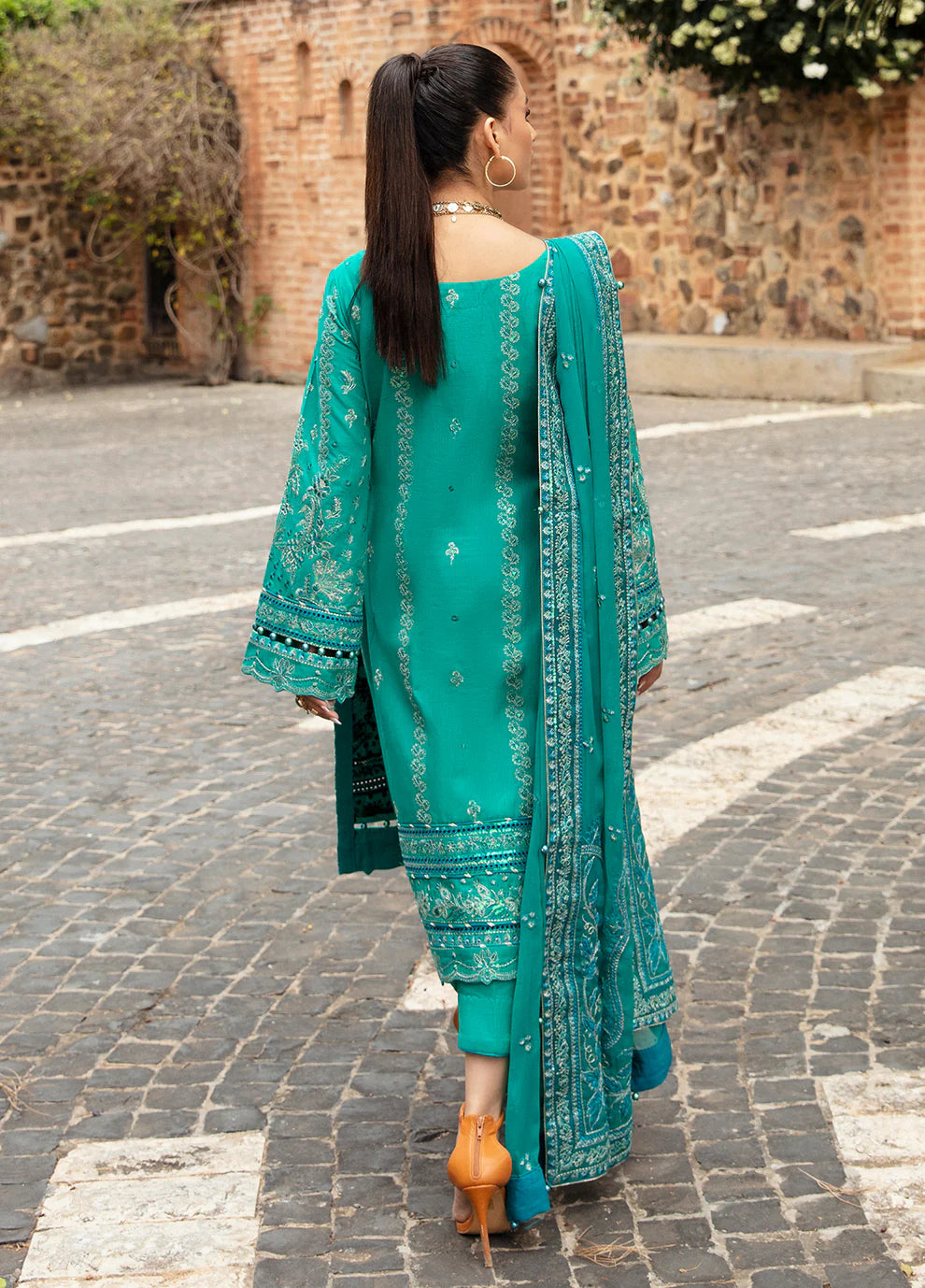 Elegant model in Gulaal's CIANA outfit, teal Pakistani attire, perfect for UK's ethnic wardrobe.