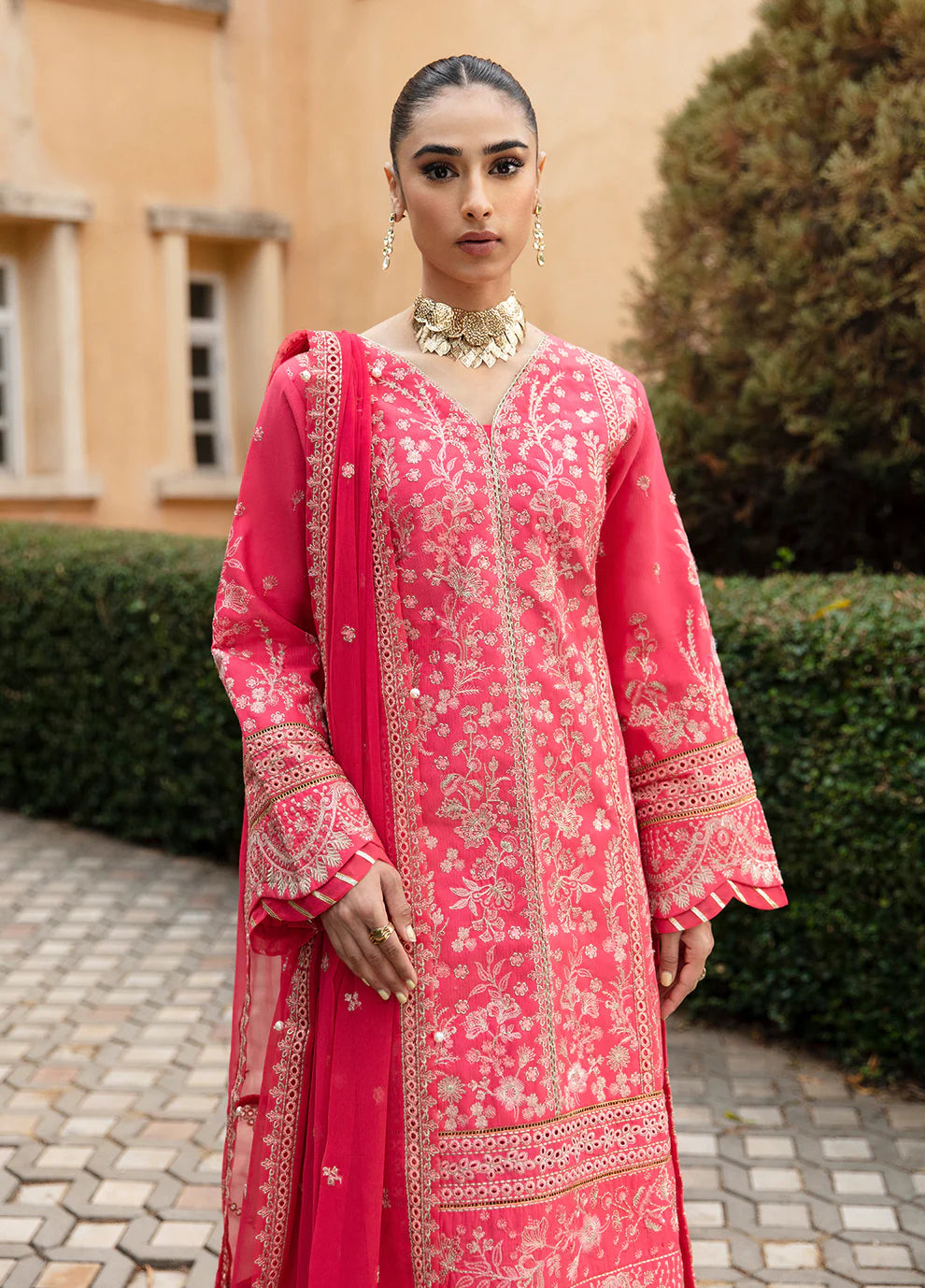 Model in Gulaal's ALESSIA dress, pink luxury lawn with exquisite detailing, a UK Pakistani fashion staple.