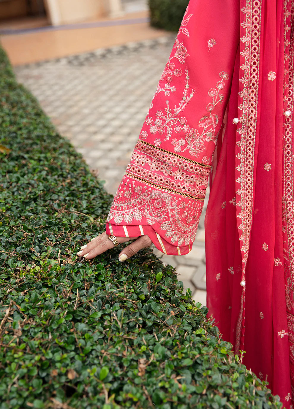 Model in Gulaal's ALESSIA dress, pink luxury lawn with exquisite detailing, a UK Pakistani fashion staple.