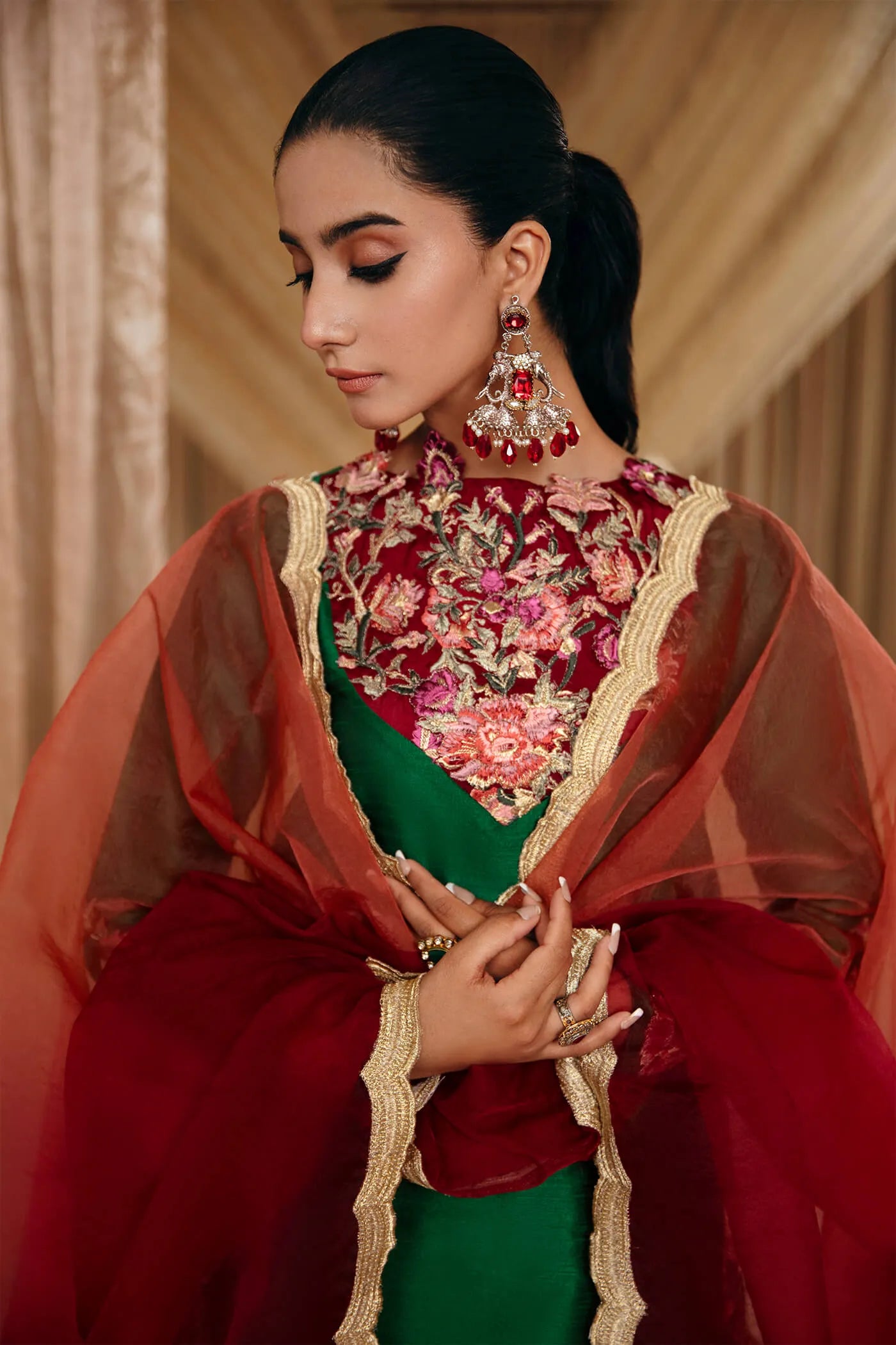 Model wearing Faiza Saqlain's Emerald Garden dress from the Musferah Saad Mystere Eid Collection '24. A stunning green Pakistani Eid dress adorned with rich embroidery, perfect for those seeking Pakistani designer clothes in the UK.