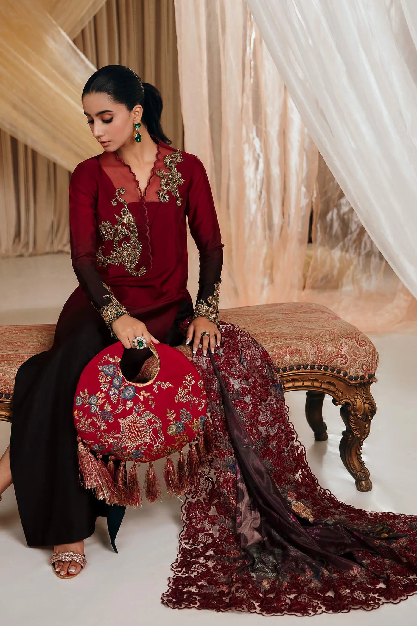 Model wearing Faiza Saqlain's Crimson Rose dress from the Musferah Saad Mystere Eid Collection '24. A striking maroon Pakistani Eid dress with gold embroidery and a beautifully detailed dupatta, ideal for Pakistani designer clothes shoppers in the UK.