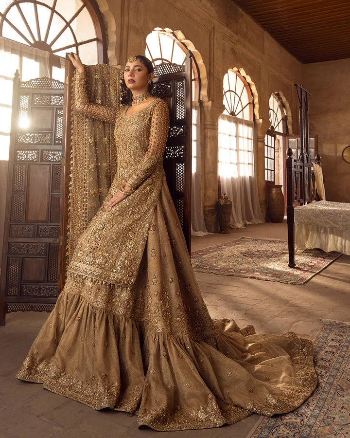 Model wearing golden brown bridal dress Naisha by Faiza Saqlain, Pakistani luxury pret online in UK for weddings.