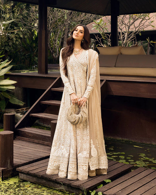 Model wearing ivory Ilima dress from Faiza Saqlain Zinnia collection, Pakistani Luxury pret, Pakistani clothes online in UK.
