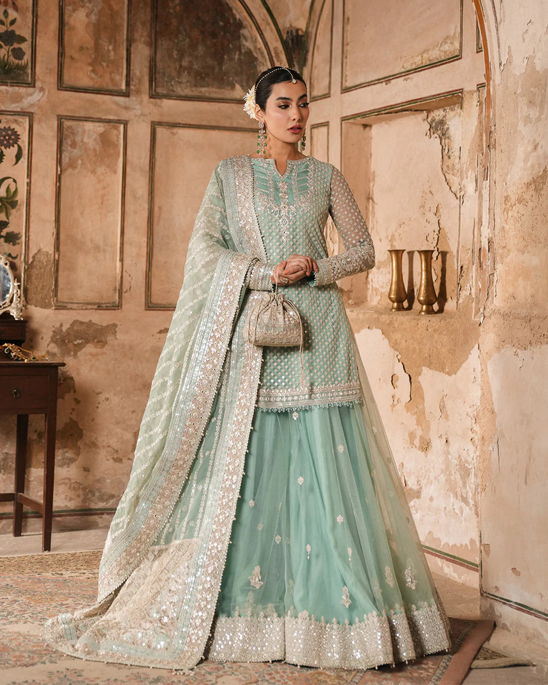 Model wearing mint green Faiza Saqlain Valari outfit with embellished net dupatta and lehenga, perfect for Pakistani luxury pret in UK.