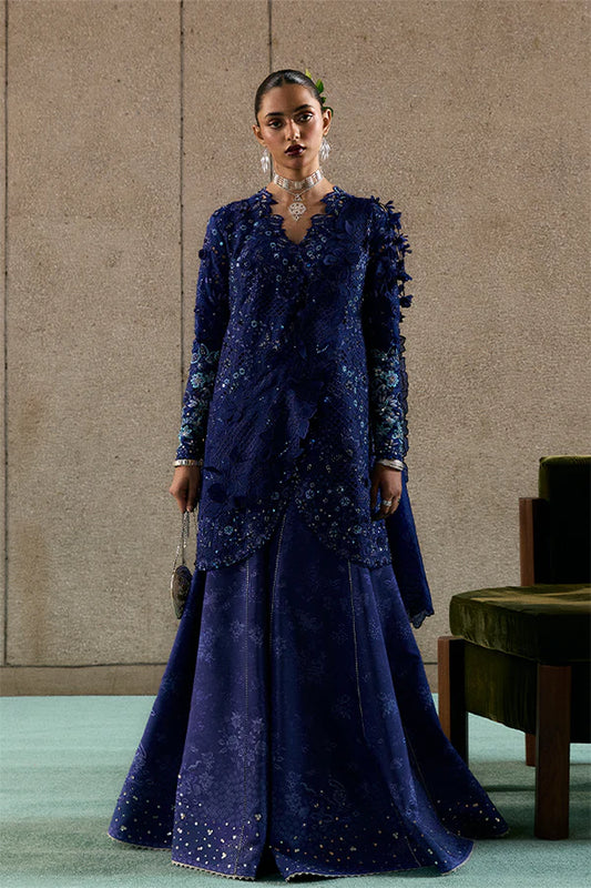 Model wearing indigo blue embellished ensemble from Suffuse Freyssa, Pakistani luxury pret, shop Pakistani clothes online in UK
