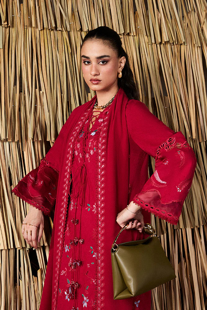 Model wearing Nivvi by Suffuse in deep red, a printed and embroidered Pakistani luxury pret outfit – shop Pakistani clothes online in UK.