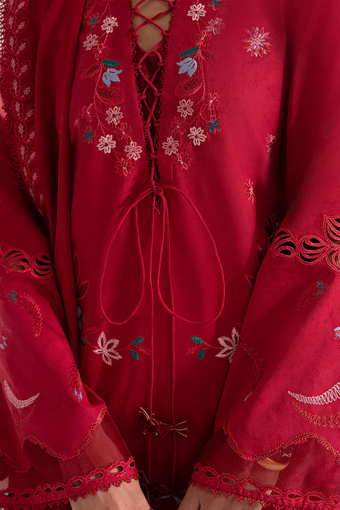 Model wearing Nivvi by Suffuse in deep red, a printed and embroidered Pakistani luxury pret outfit – shop Pakistani clothes online in UK.