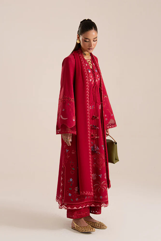 Model wearing Nivvi by Suffuse in deep red, a printed and embroidered Pakistani luxury pret outfit – shop Pakistani clothes online in UK.